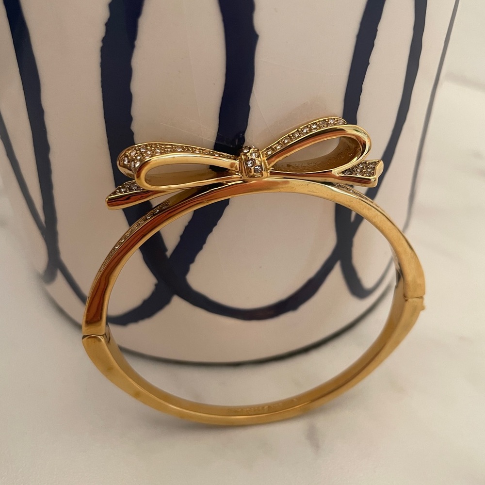 Gold Kate Spade New York bangle bracelet with bow detail